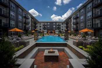 An outdoor courtyard with a pool and an apartment building